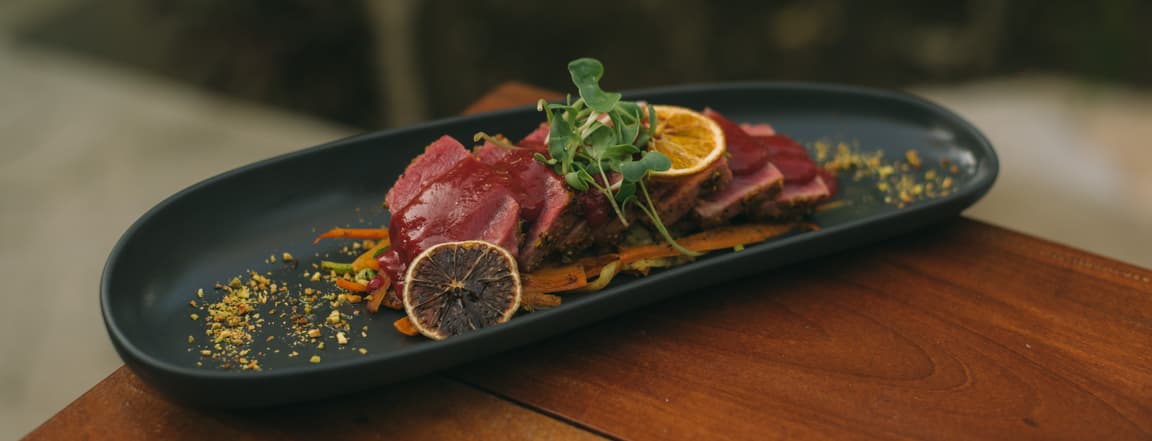 Red tuna tataki in pistachio crust wist raspberry souce