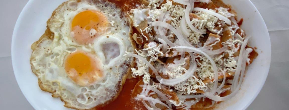 Chilaquiles with red sauce and egg.