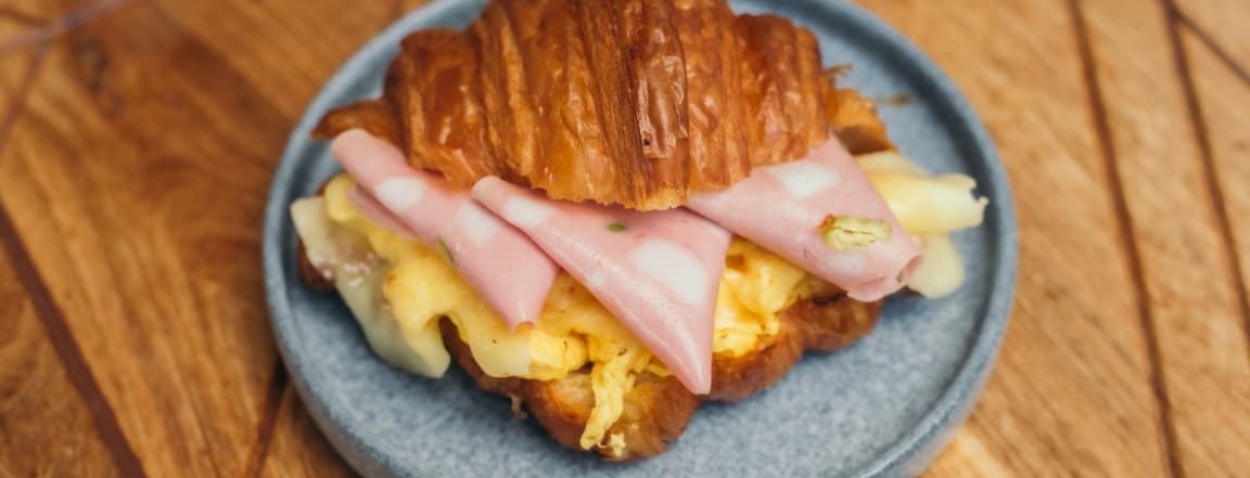 Croissant with mortadella ham, eggs and cheese
