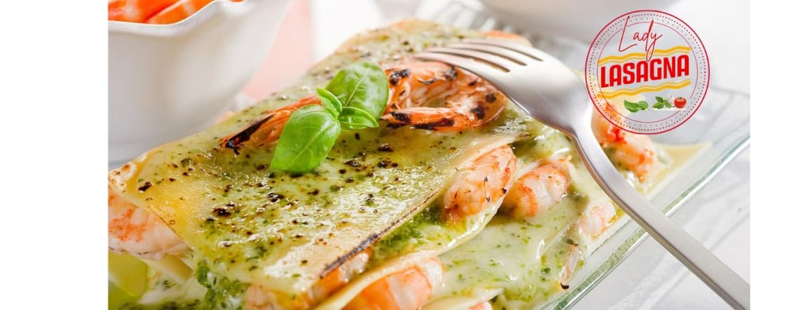 Pasta lasagna with shrimps, zucchini and italian pesto of basil