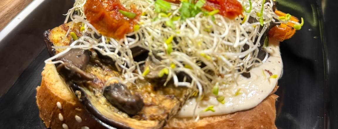 Hummus toast with antipasti