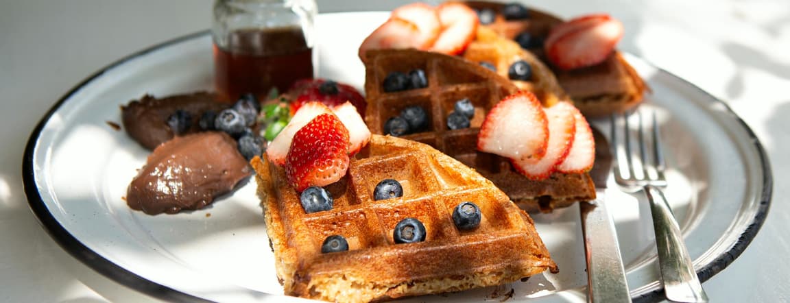 Warm welcome waffles with organic maple syrup & berries